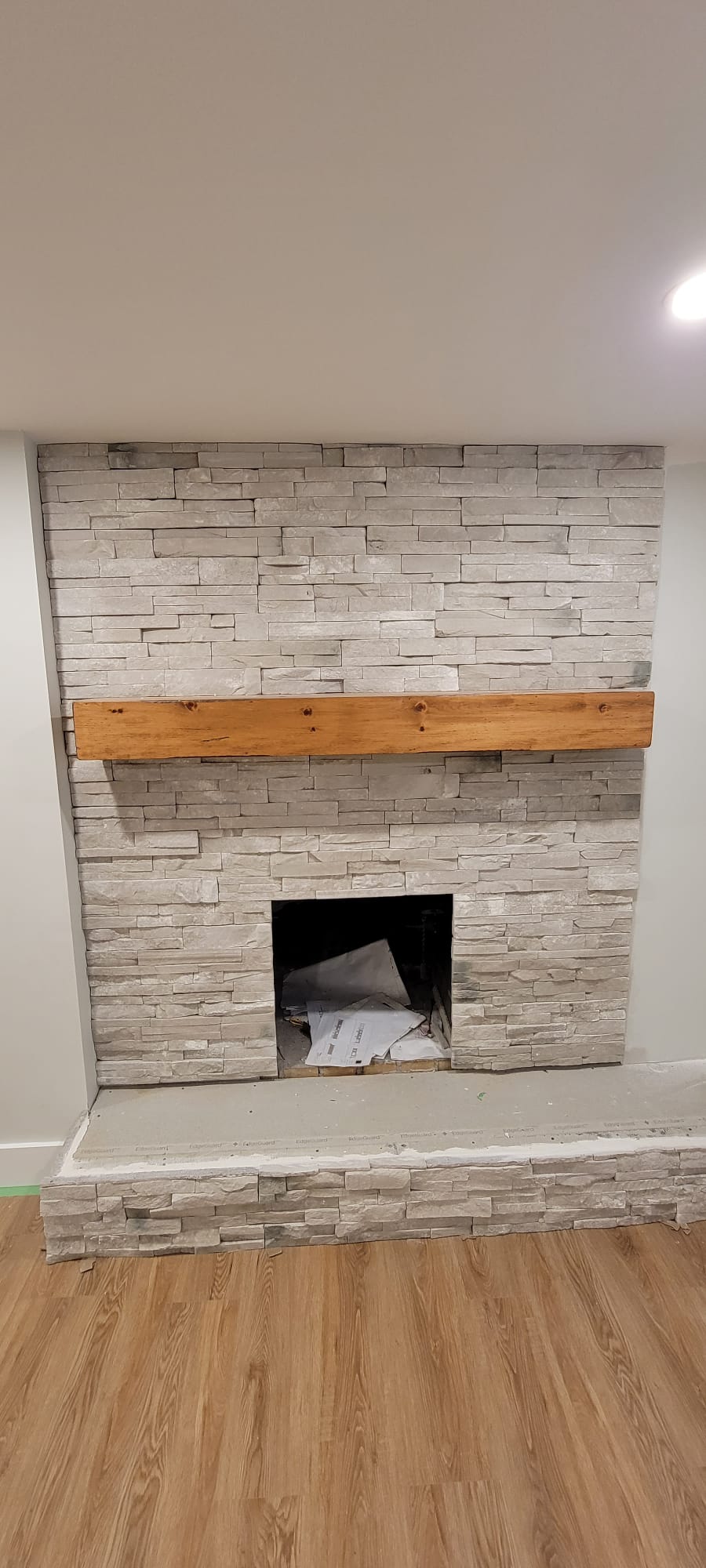 Natural stacked stone fireplace surround